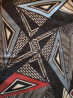 Large Geometric pattern in shades of blue, black, and red.